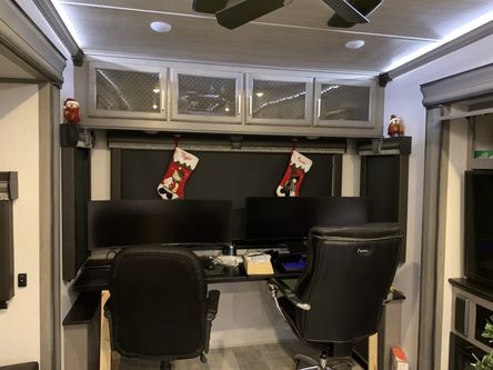 New desk in back of RV with chairs and monitors
