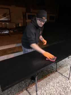 Brent applying a final coat of stain to the new desk surface