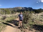 Tayler standing on a rocky trail in the Sandia Mountains