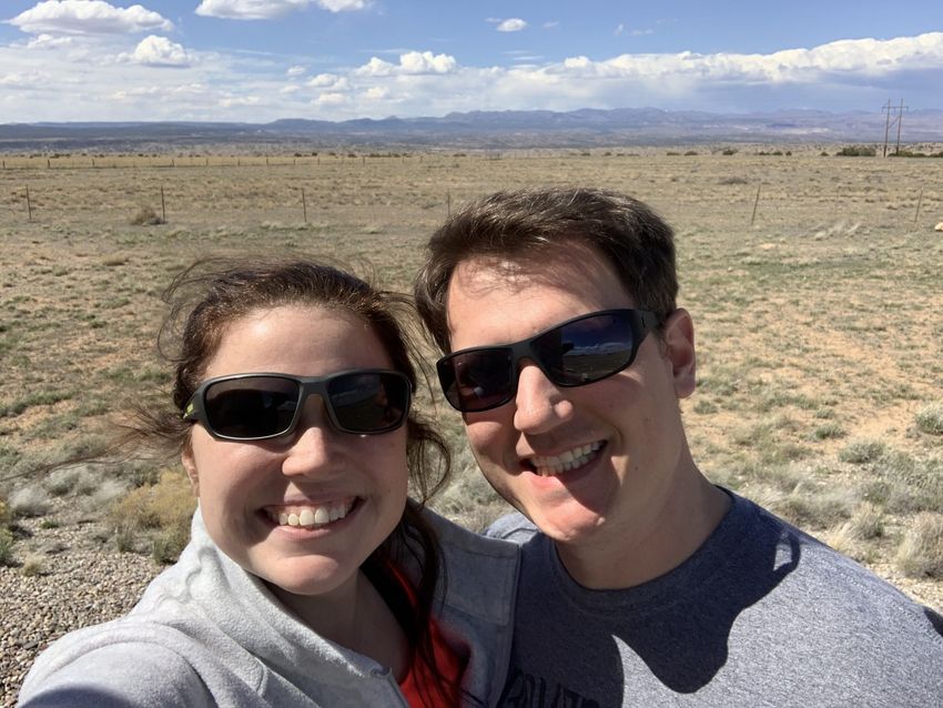 Brent and Tayler taking a selfie with the wide open prairie near the Mormon Battalion Monument in the background