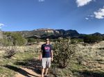 Brent standing on a rocky trail in the Sandia Mountains