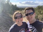 Brent and Tayler taking a selfie amongst shrubs on the trail