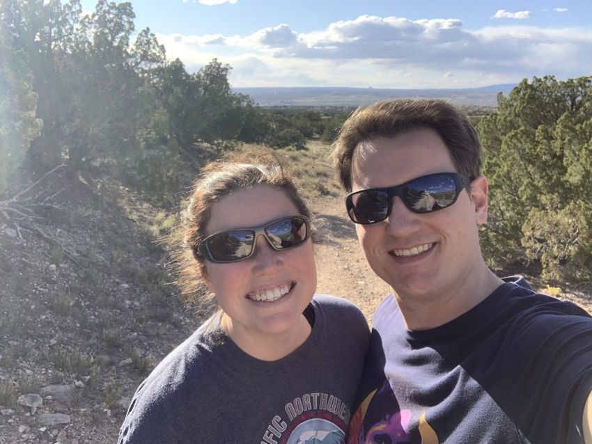 Brent and Tayler taking a selfie amongst shrubs on the trail